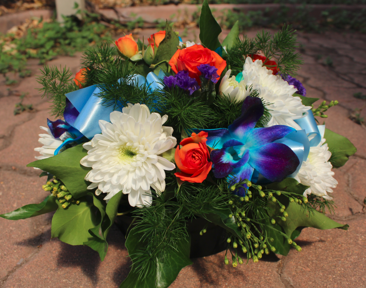 closeup of previous arrangement. Flowers used were blue orchids, white chrysanthemums and orange roses