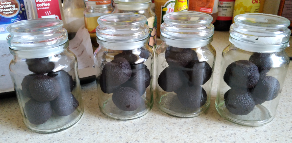 Balls of tablea chocolate in glass jars