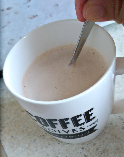 Tablea chocolate being stirred into hot milk