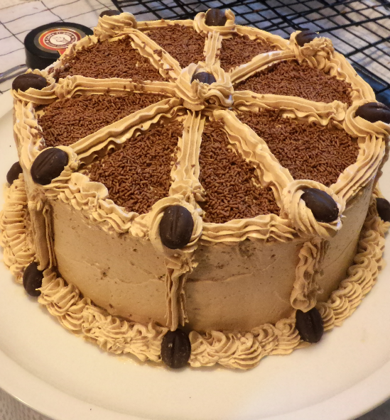 Filipino-style mocha cake with coffee buttercream and dark chocolate coffee bean candies and sprinkles