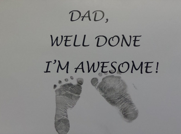 Card with baby footprints and text reading Dad, Well Done I'm Awesome!
